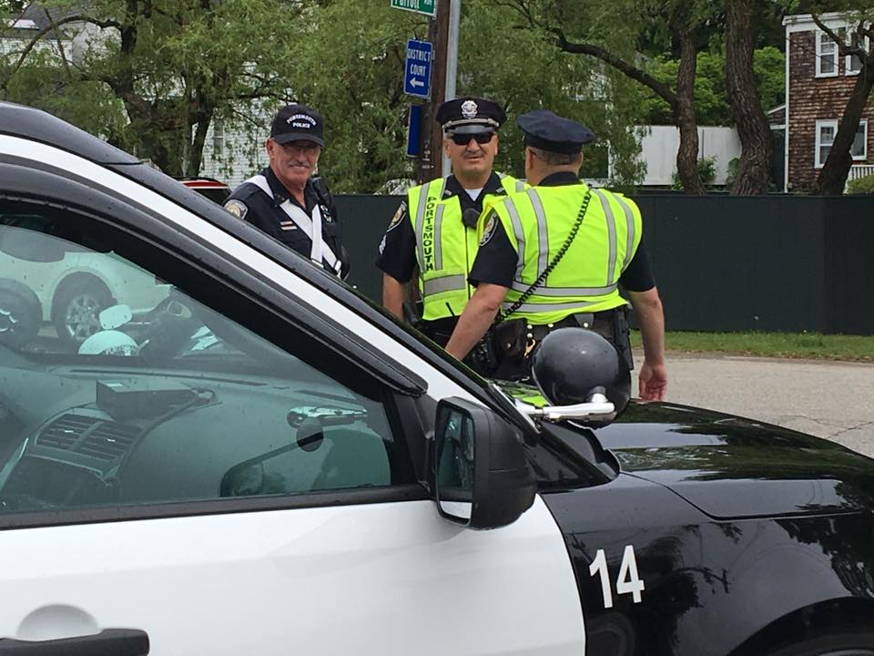 Police Auxiliary conferring with other officers