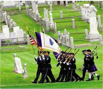 Honor Guard marching through cemetery on Memorial Day