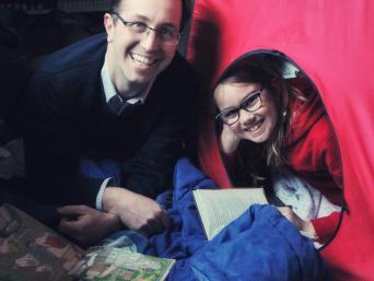 Father and daughter in a tent