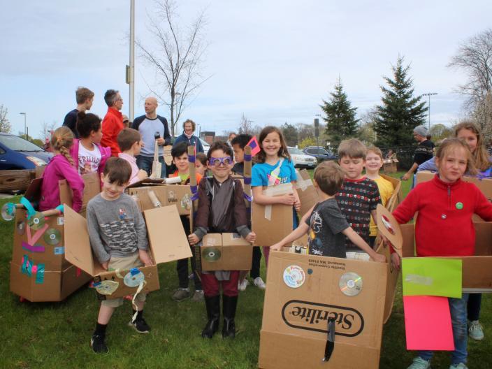 Crowd of children in homemade spaceships getting ready to race