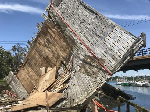 Demolishing collapsed pier building at 95 Mechanic Street.