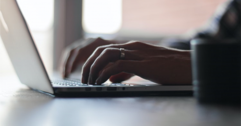 Hands Typing on Computer