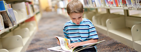 Boy reading in library