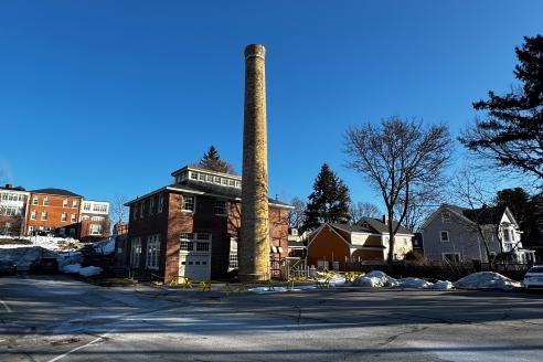 Image of the boiler house and chimney on a clear blue day