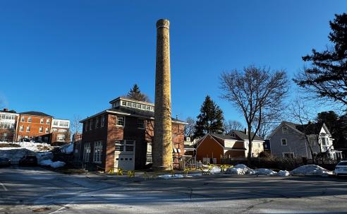 Image of the boiler house and chimney on a clear blue day